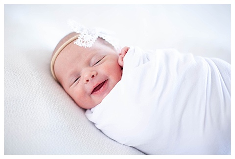 Adorable swaddled baby smiling 
