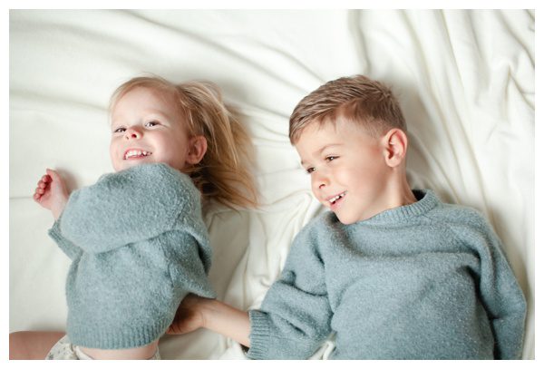 Brother tickling sister in family photos