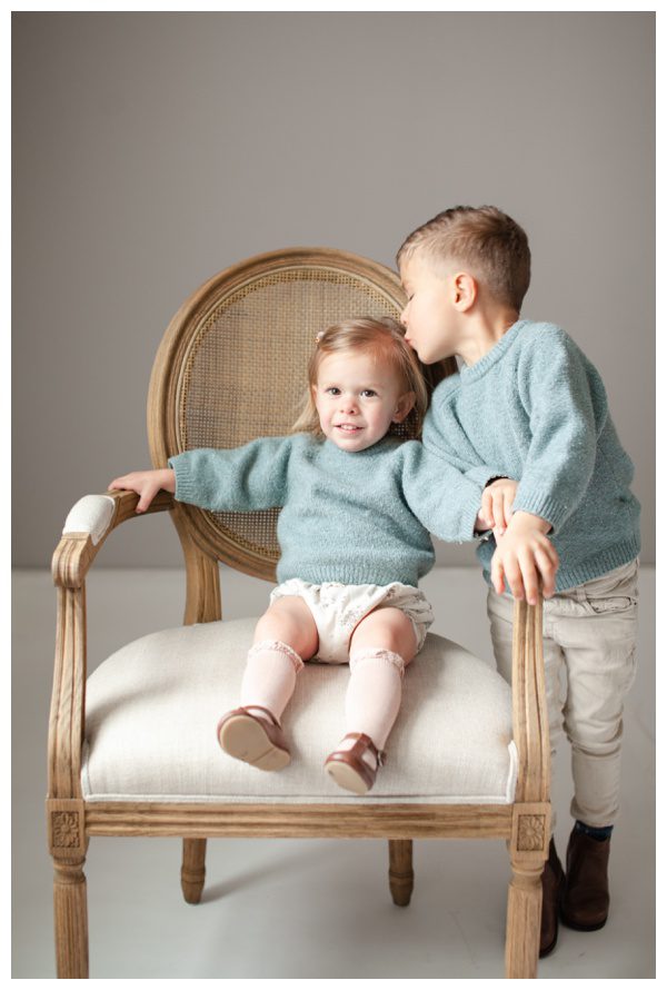 Older brother kissing little sister in family pictures