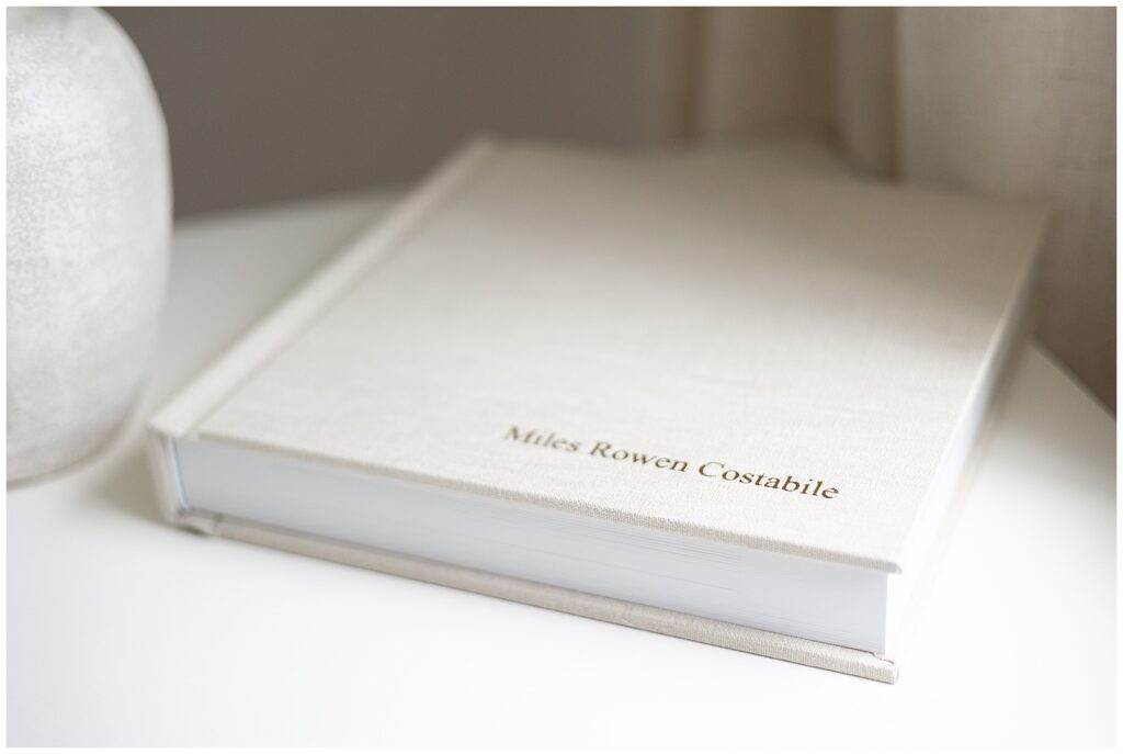 Fine quality, luxurious baby album. Linen cover material with golf foil debossing of baby's full name. 10x10 archival album with thick board pages and high quality digital printing by a newborn photography studio located in Fairfield County CT.