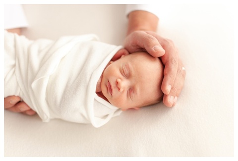 Light and airy newborn portraits in a photography studio