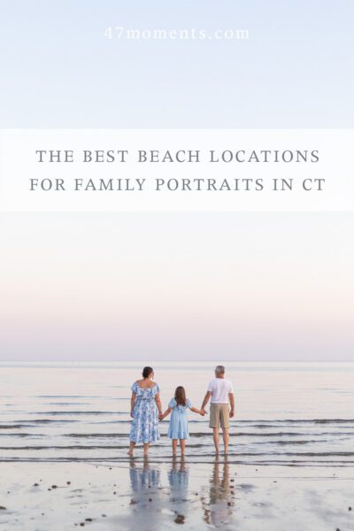 Family holding hands looking out at the horizon while standing on Fairfield Beach. Beautiful soft pink sky and coordinating outfits.