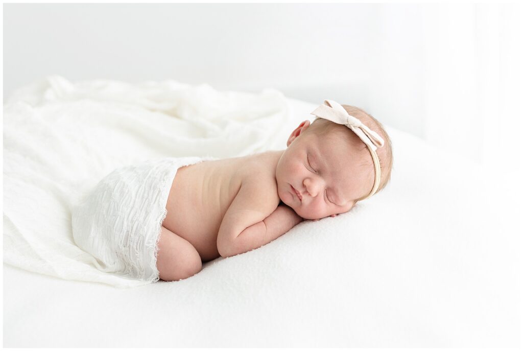 Baby on belly for sleepy newborn portraits