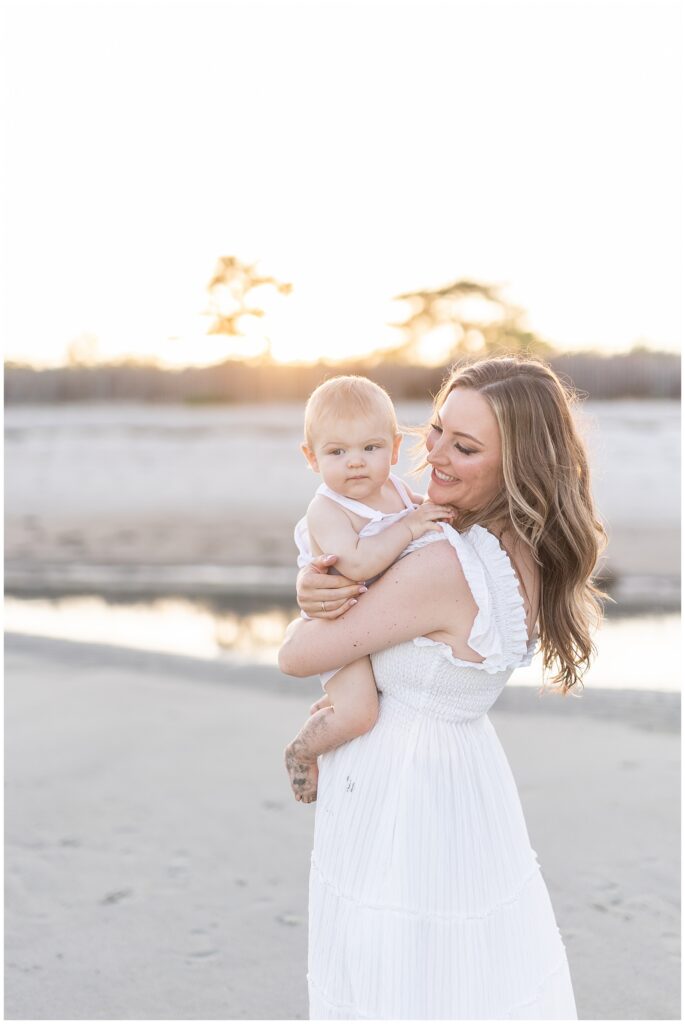 Golden hour beach portraits with mom and 6 month old baby by Forty Seven Moments photography. CT photographer near me in Greenwich CT.